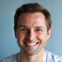 Professional portrait of a smiling man with a clean background