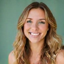 Professional portrait of a smiling woman with a clean background